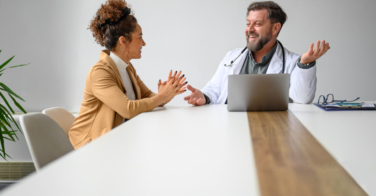 A friendly physician consulting with a patient in a warm, inviting medical office, symbolizing personalized, patient-centered care.
